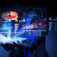 Businesswoman with financial symbols coming from her hand